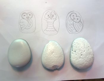 planning owl designs on paper with a pencil
